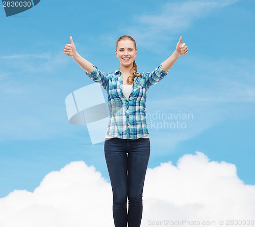Image of smiling girl in casual clothes showing thumbs up