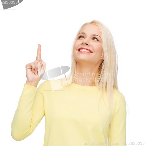 Image of smiling woman pointing her finger up