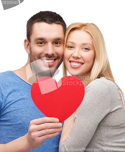Image of smiling couple holding big red heart