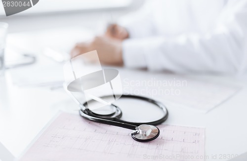 Image of male doctor hands with cardiogram