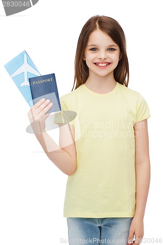 Image of smiling little girl with ticket and passport