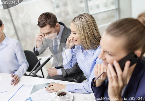 Image of business team with smartphones having conversation