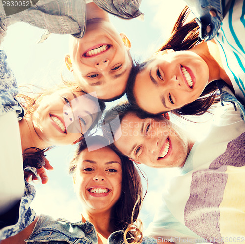 Image of group of teenagers looking down