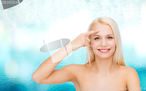 Image of beautiful woman touching her forehead