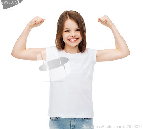 Image of little girl in blank white t-shirt showing muscles