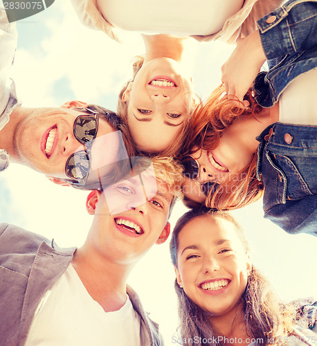 Image of group of teenagers looking down