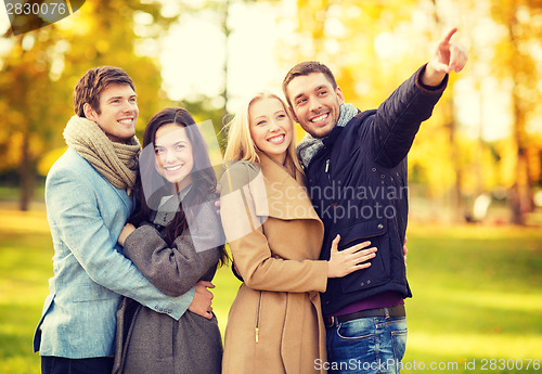 Image of group of friends having fun in autumn park