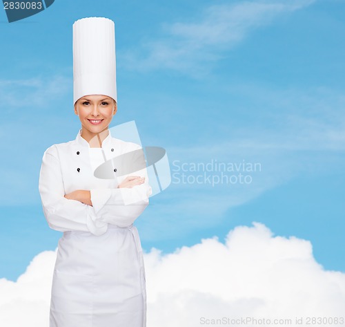 Image of smiling female chef with crossed arms