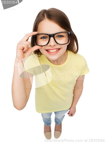 Image of smiling cute little girl in black eyeglasses