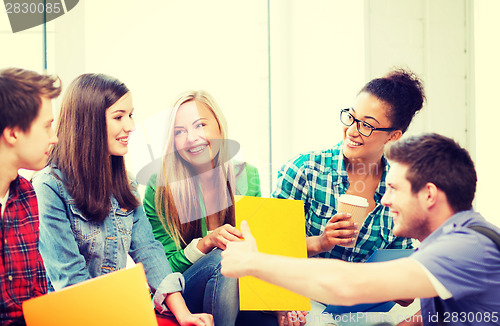 Image of students communicating and laughing at school