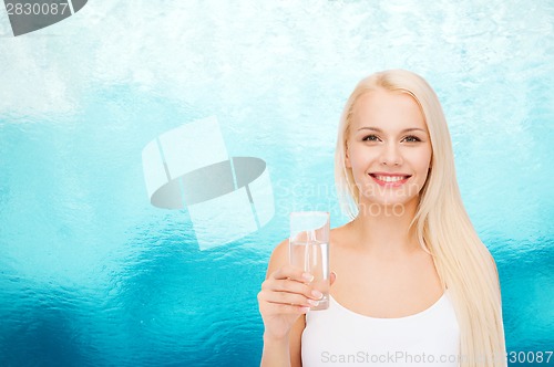 Image of young smiling woman with glass of water