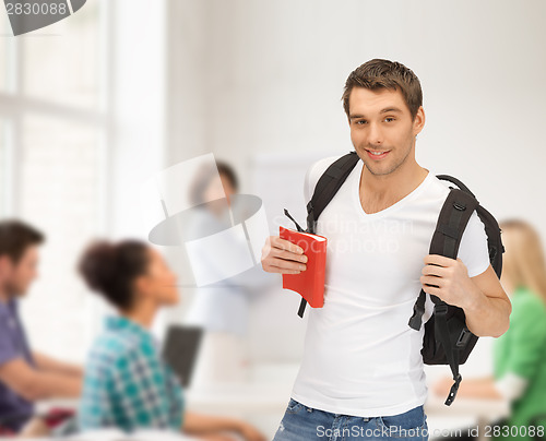 Image of travelling student with backpack and book