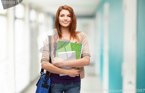Image of smiling student with bag, folders and tablet pc