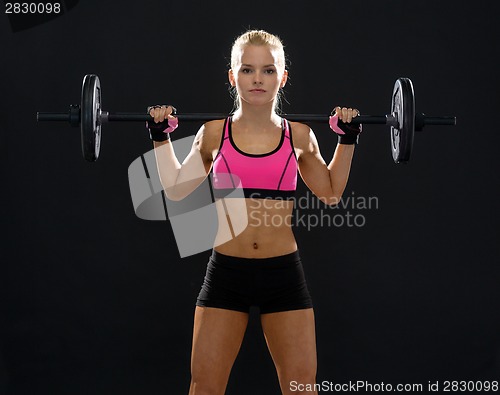 Image of sporty woman exercising with barbell