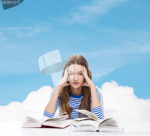 Image of stressed student girl with books