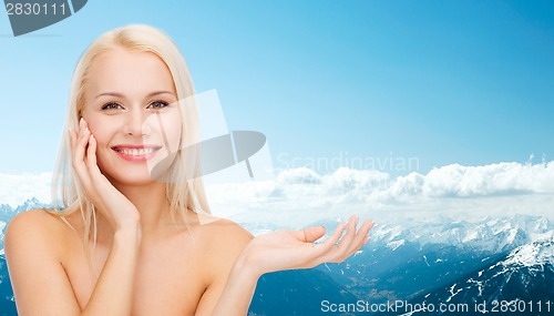 Image of smiling woman holding imaginary lotion jar