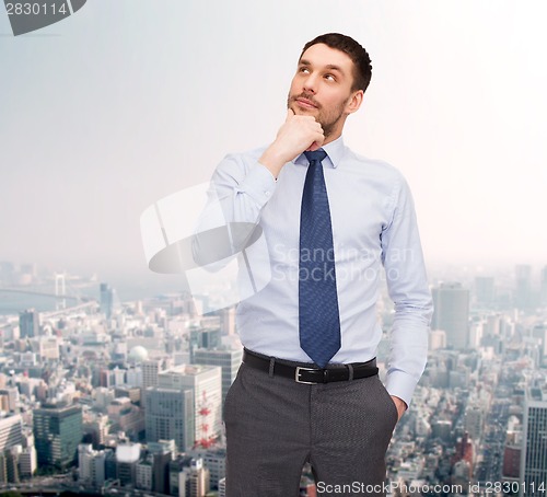 Image of handsome businessman looking up