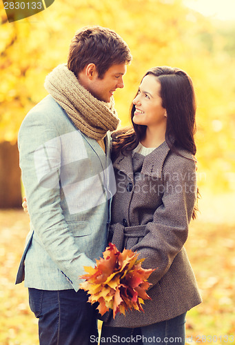 Image of romantic couple kissing in the autumn park