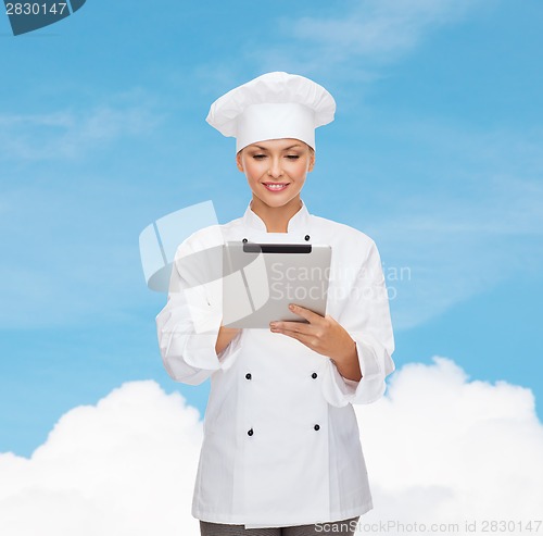 Image of smiling female chef with tablet pc computer