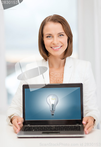 Image of smiling businesswoman with laptop computer