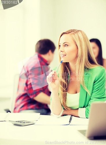 Image of student girl with notebook and calculator