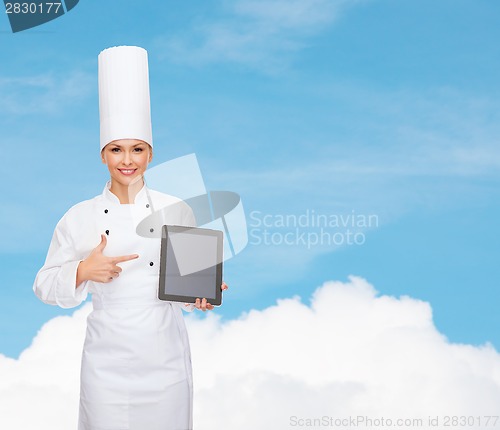 Image of smiling female chef with tablet pc blank screen