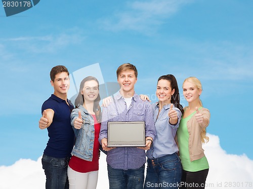Image of smiling students with laptop computer
