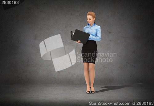 Image of smiling businesswoman with folder