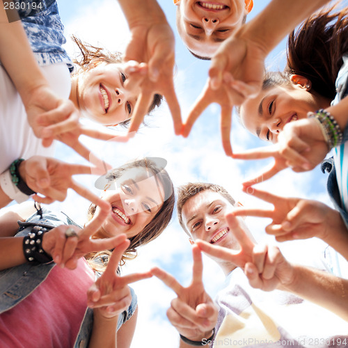 Image of group of teenagers showing finger five