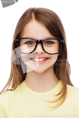 Image of smiling cute little girl in black eyeglasses