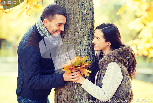 Image of romantic couple playing in the autumn park