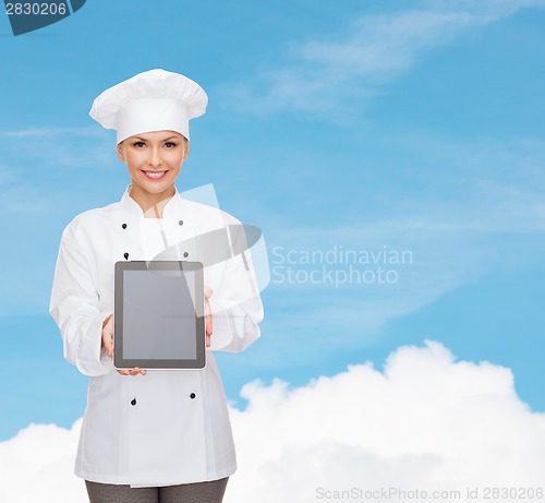 Image of smiling female chef with tablet pc blank screen