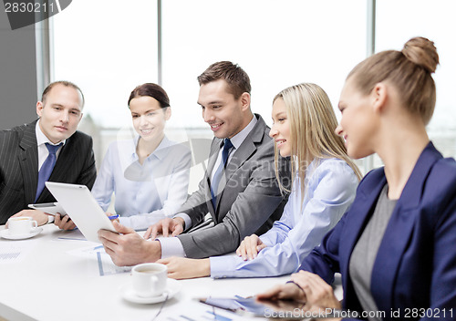 Image of business team with tablet pc having discussion