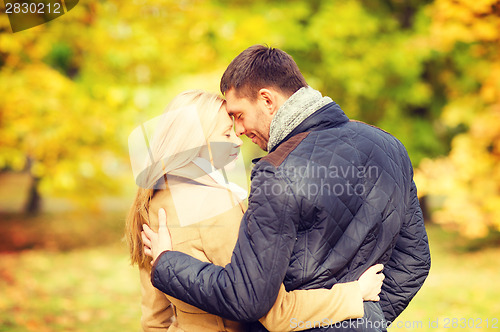 Image of romantic couple kissing in the autumn park