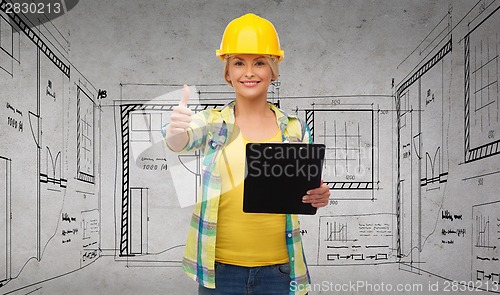 Image of smiling woman in helmet with clipboard