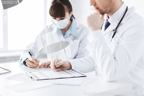 Image of doctor and nurse writing prescription paper