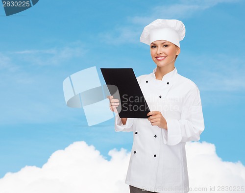 Image of smiling female chef with black blank paper