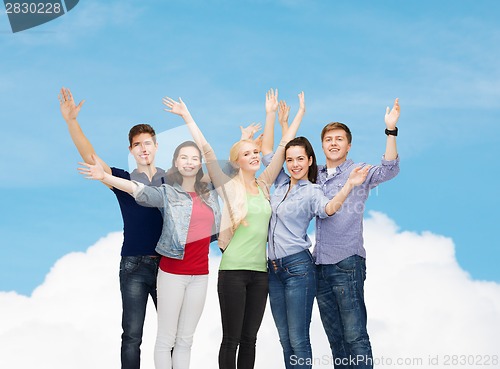 Image of group of smiling students waving hands