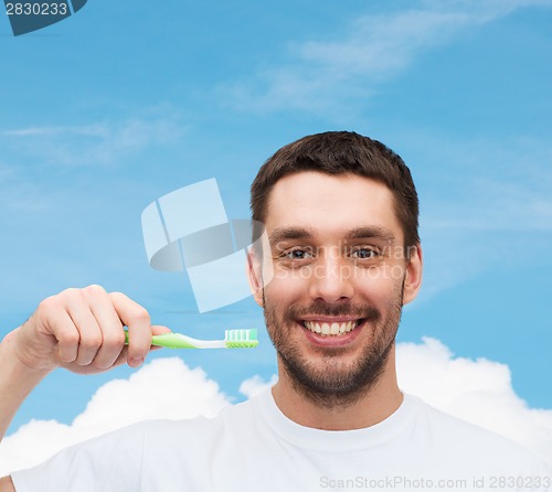 Image of smiling young man with toothbrush