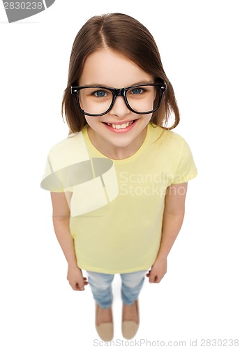 Image of smiling cute little girl in black eyeglasses