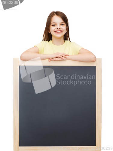 Image of happy little girl with blank blackboard