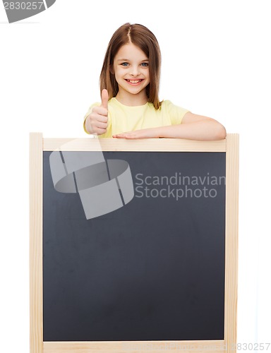 Image of happy little girl with blank blackboard