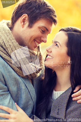 Image of romantic couple kissing in the autumn park