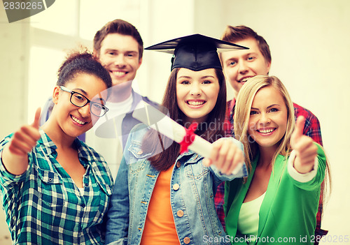 Image of girl in graduation cap with certificate