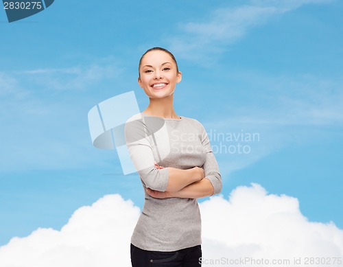 Image of smiling asian woman over with crossed arms