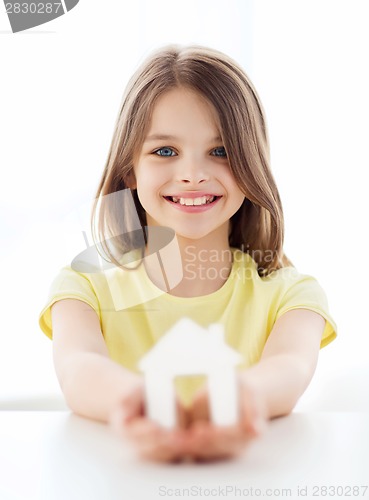 Image of little girl holding white paper house