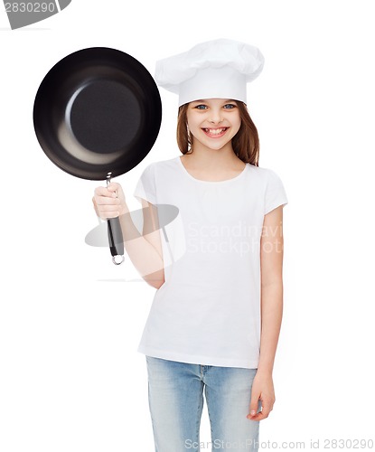 Image of smiling girl in cook hat with frying pan