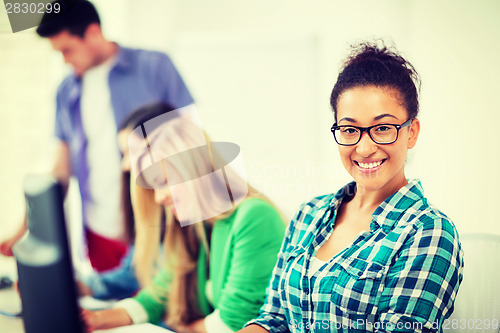 Image of student with computer studying at school