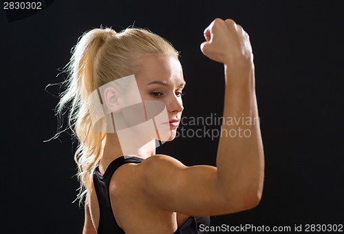 Image of close up of athletic woman flexing her biceps