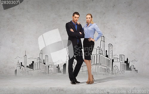 Image of serious businessman and businesswoman